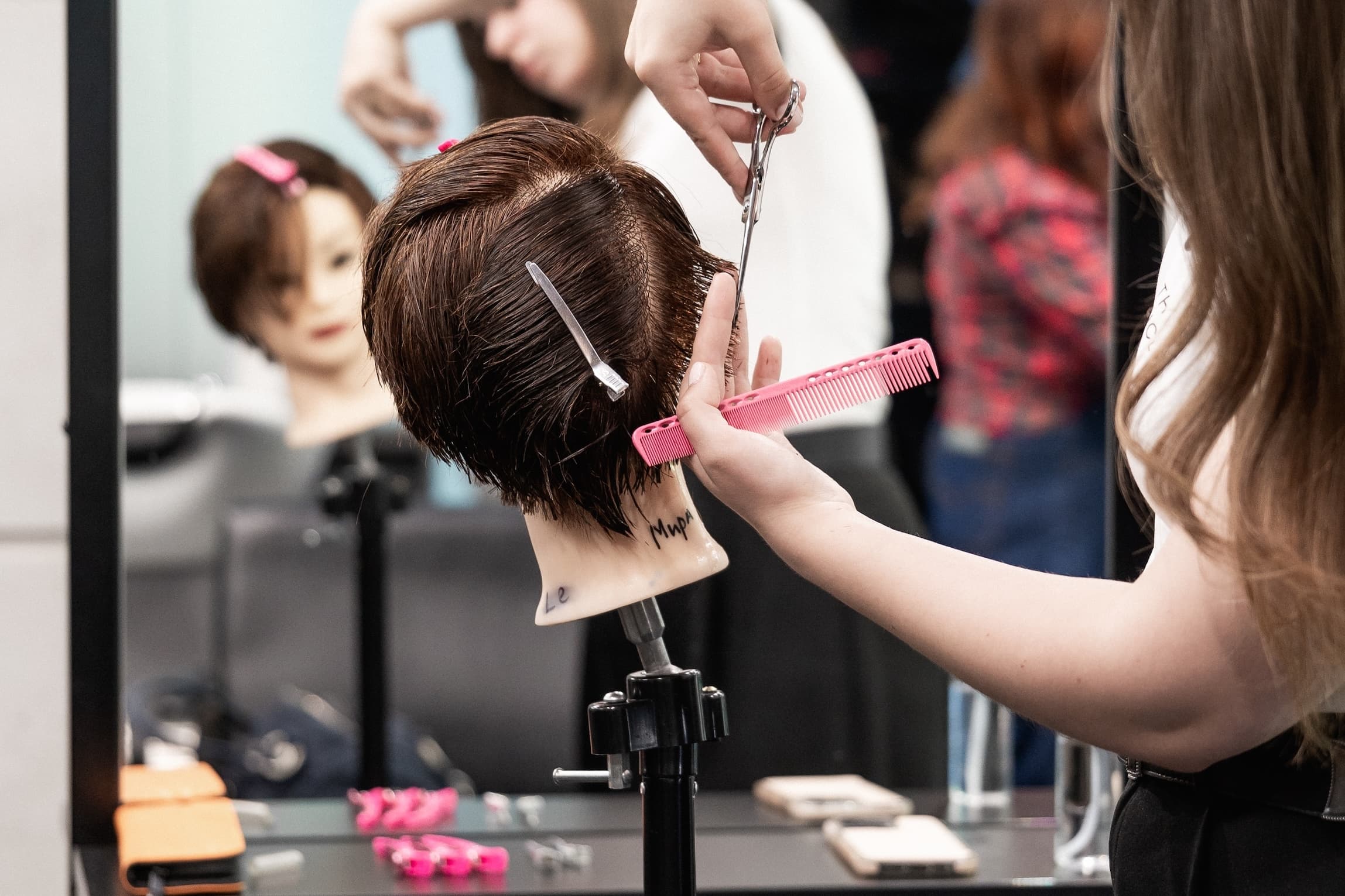 A teenager working on a training head